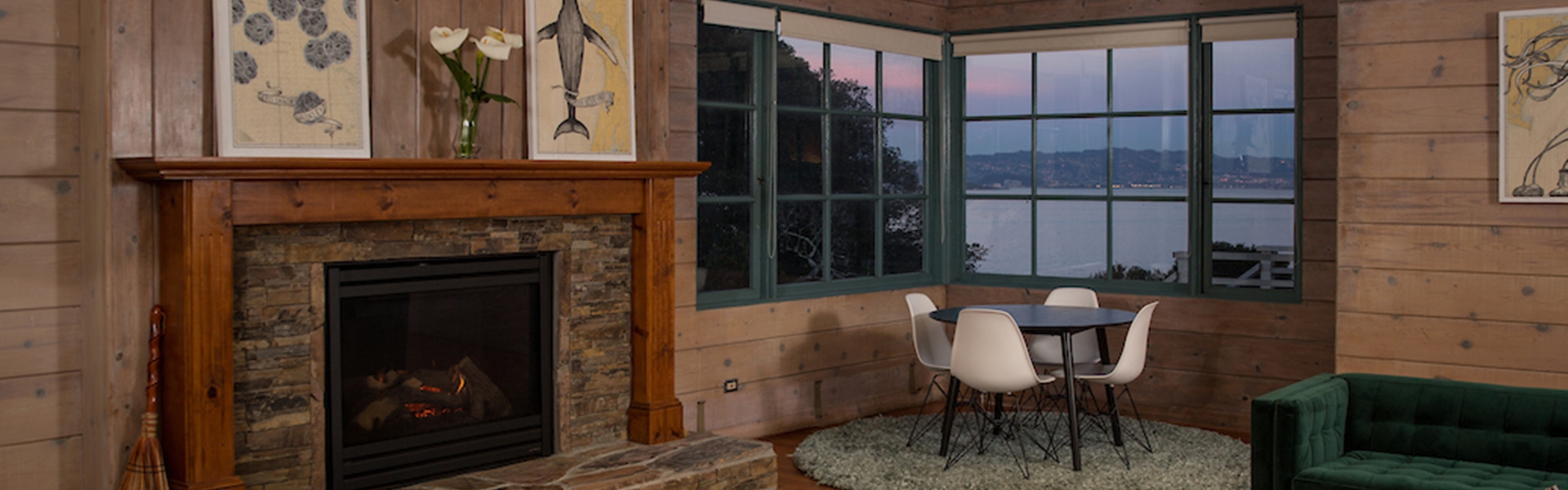 hearth lounge with fireplace and sunset view out windows