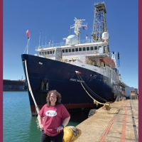 Laura Guertin in front of docked research vessel