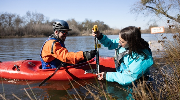Researchers in water and kayak